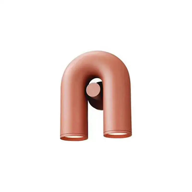 Copper-colored u-shaped wall lamp with sleek minimalist design for modern tube wall decorbites cirkus tube lighting