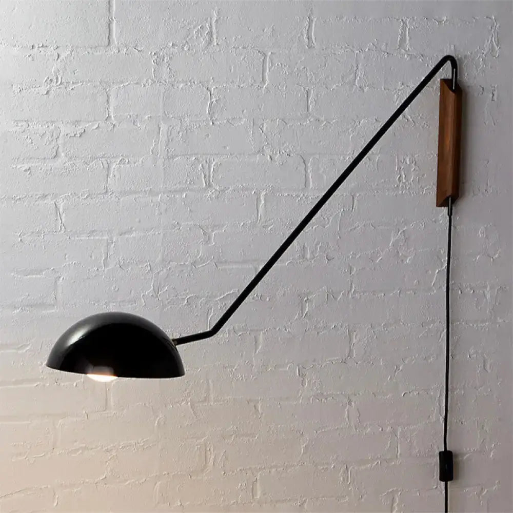 Modern matte black swing arm bedside wall lamp with wooden accent and articulated arm mounted on wall