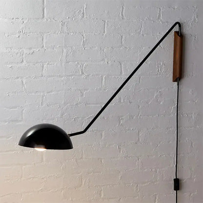 Modern matte black swing arm bedside wall lamp with wooden accent and articulated arm mounted on wall