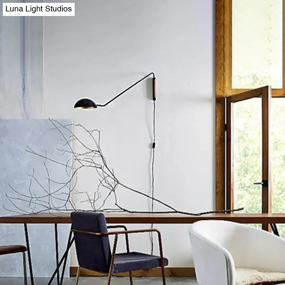 Modern matte black swing arm bedside wall lamp with wood accent and minimalist design mounted on wall