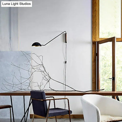 Modern matte black swing arm bedside wall lamp with wood accent and minimalist design mounted on wall