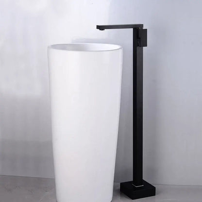 Modern matte black tall basin faucet with a sleek minimalist design paired with a white cylindrical pedestal sink