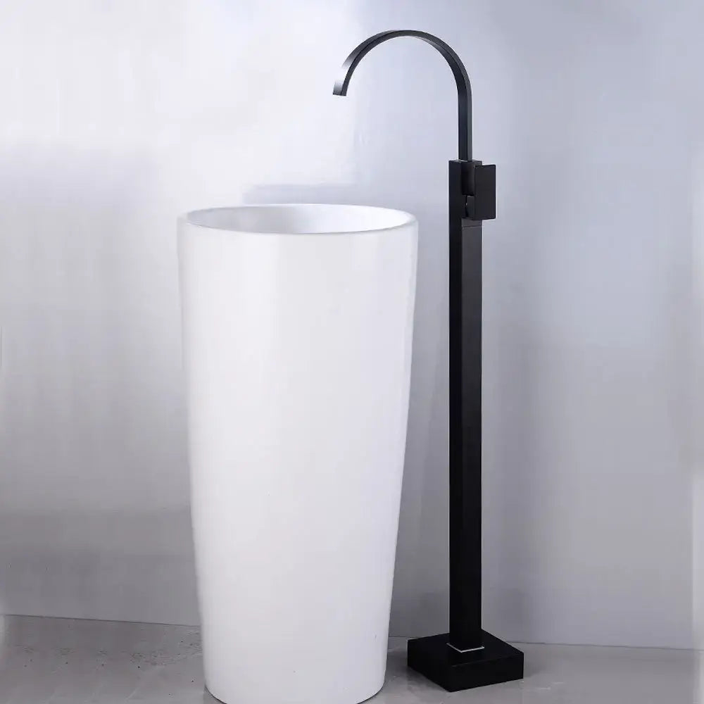 White ceramic pedestal sink paired with modern matte black tall basin faucet decorbites black tall finish