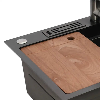 Modern matte black utility sink with stainless steel faucet and natural wood cutting board inset featuring sleek design