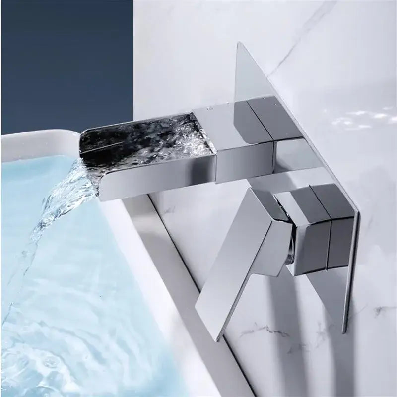 Modern chrome-finished waterfall basin mixer tap with angular geometric design for bathroom wall mounted use