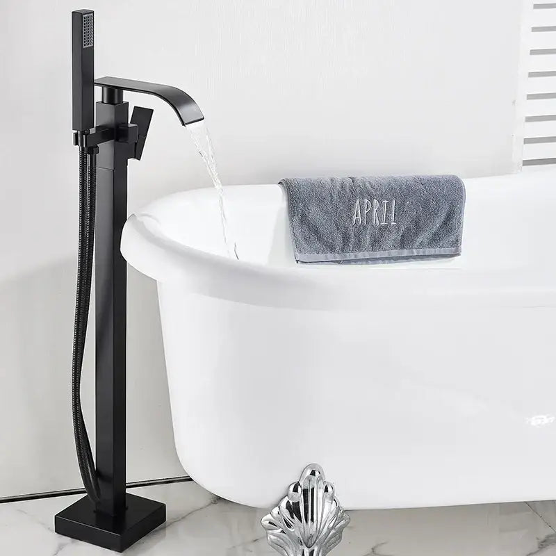 Modern matte black waterfall freestanding bathtub faucet with sleek design and integrated handheld shower by decorbites