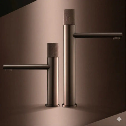 Two modern matte bronze basin faucets with textured cylindrical handles and sleek minimalist design for kitchens