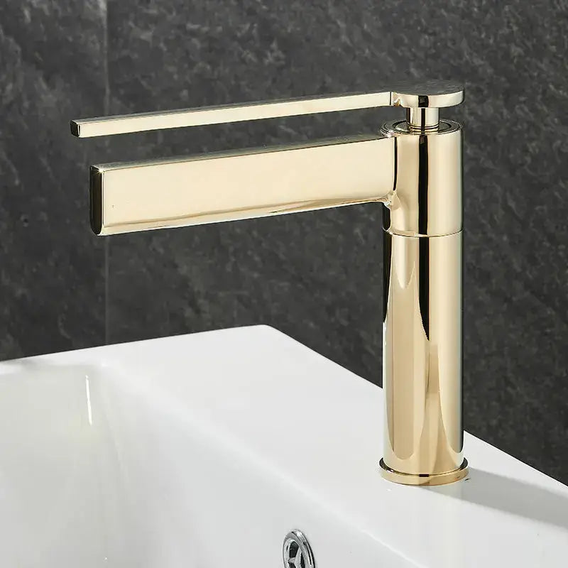 Modern gold-toned decorbites basin faucet with minimalist design and polished metallic finish for bathroom use