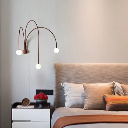 Modern matte copper wall lamp with three curved arms and white glass ball bulbs for living room decorbites glass ball modern