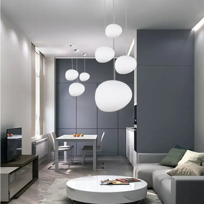 Modern matte white glass pendant light with spherical design hanging in dining room featuring decorbites gregg glass pendant light