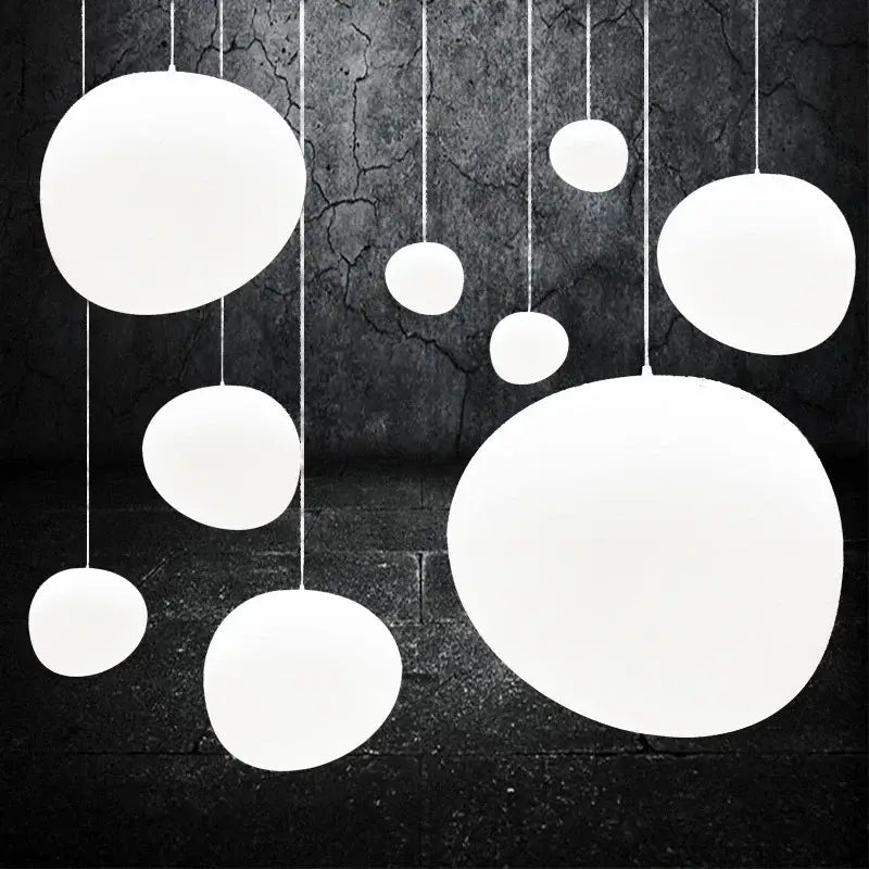 Modern matte white glass pendant light with smooth finish hanging at varying sizes ideal for kitchen and dining decorbites gregg glass pendant