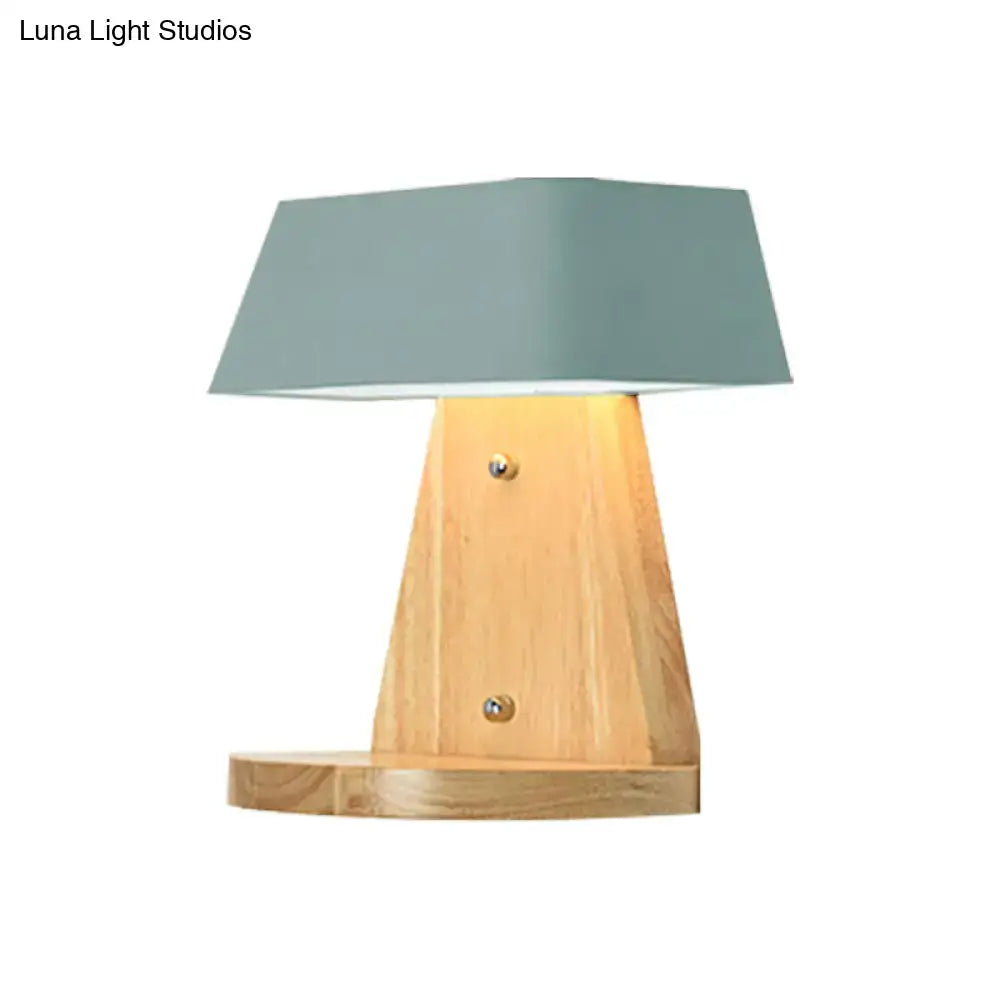 Modern metal trapezoid wall sconce with wooden backplate and matte sage green lamp shade for living room light fixture