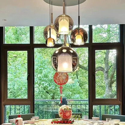 Modern chrome pendant light with spherical designer glass chandelier and red paper lantern for dining room decorbites design