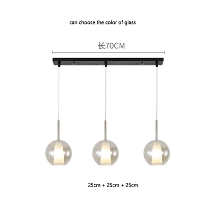 Modern minimalist pendant light with three spherical glass globes on a black bar decorbites designer glass chandelier