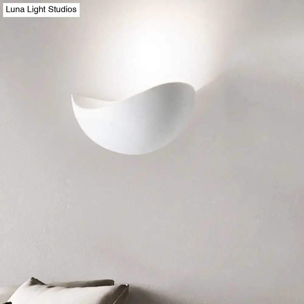 A sleek white ceramic metallic wall washer light with a smooth curved design for modern bedroom decor