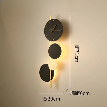 Modern black circular led wall clock sconce with gold-toned accents and integrated lighting for living room home decor