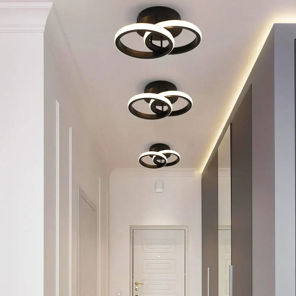 Modern minimalist black acrylic led ceiling lamp with intersecting circular rings for bedroom lighting by decorbites acrylic led