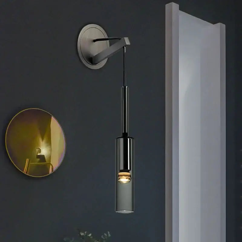 Modern minimalist black crystal wall lamp with sleek cylindrical glass shade and brushed metal arm for bedroom decorbites crystal wall use