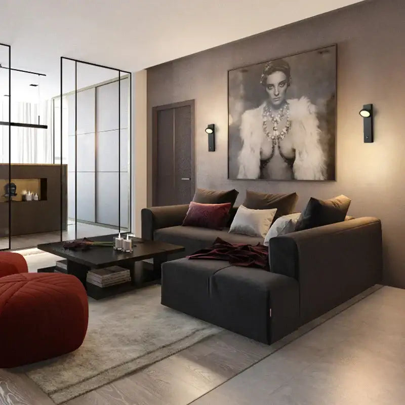 Dark gray sectional sofa with plush cushions and maroon throw beside modern minimalist decorbites dimmable led wall lamp