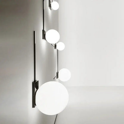 Modern minimalist black wall lights with sleek metal frame and five frosted white glass ball globes for bedroom use