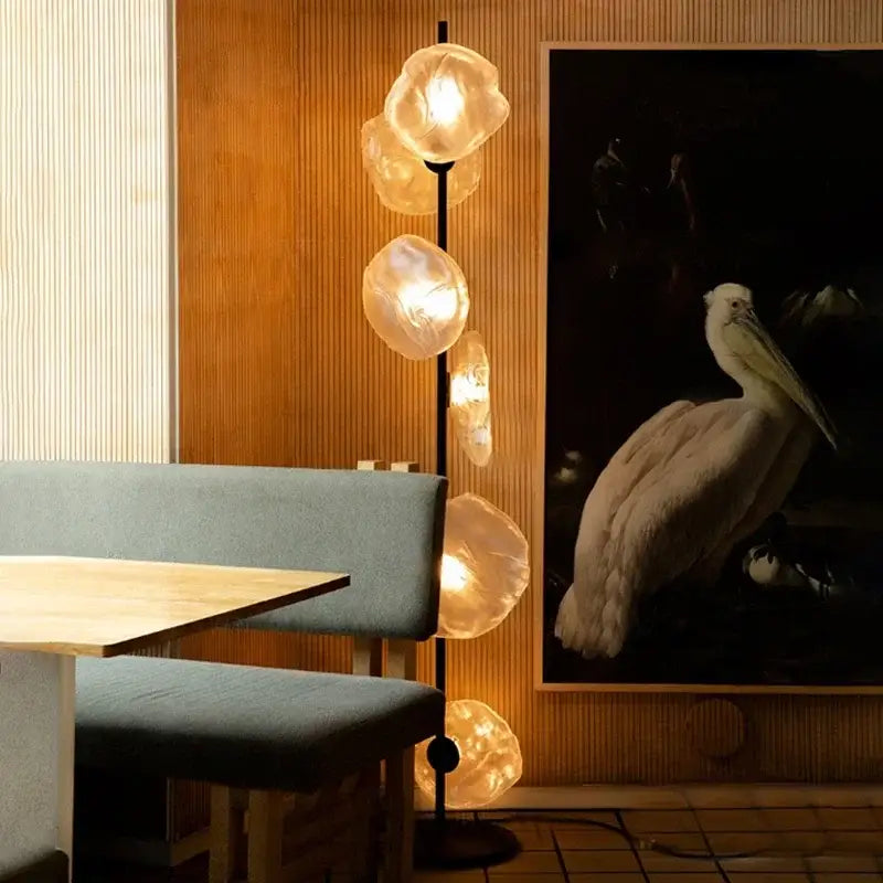 Modern minimalist floor lamp with a black pole and five amber glass shade led orbs for stylish home decor