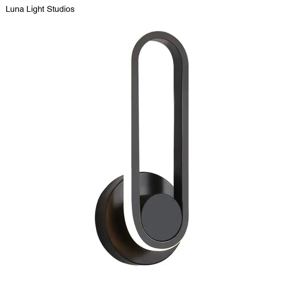 Modern minimalist black matte oval led wall sconce with sleek design enhancing natural colors in living room light