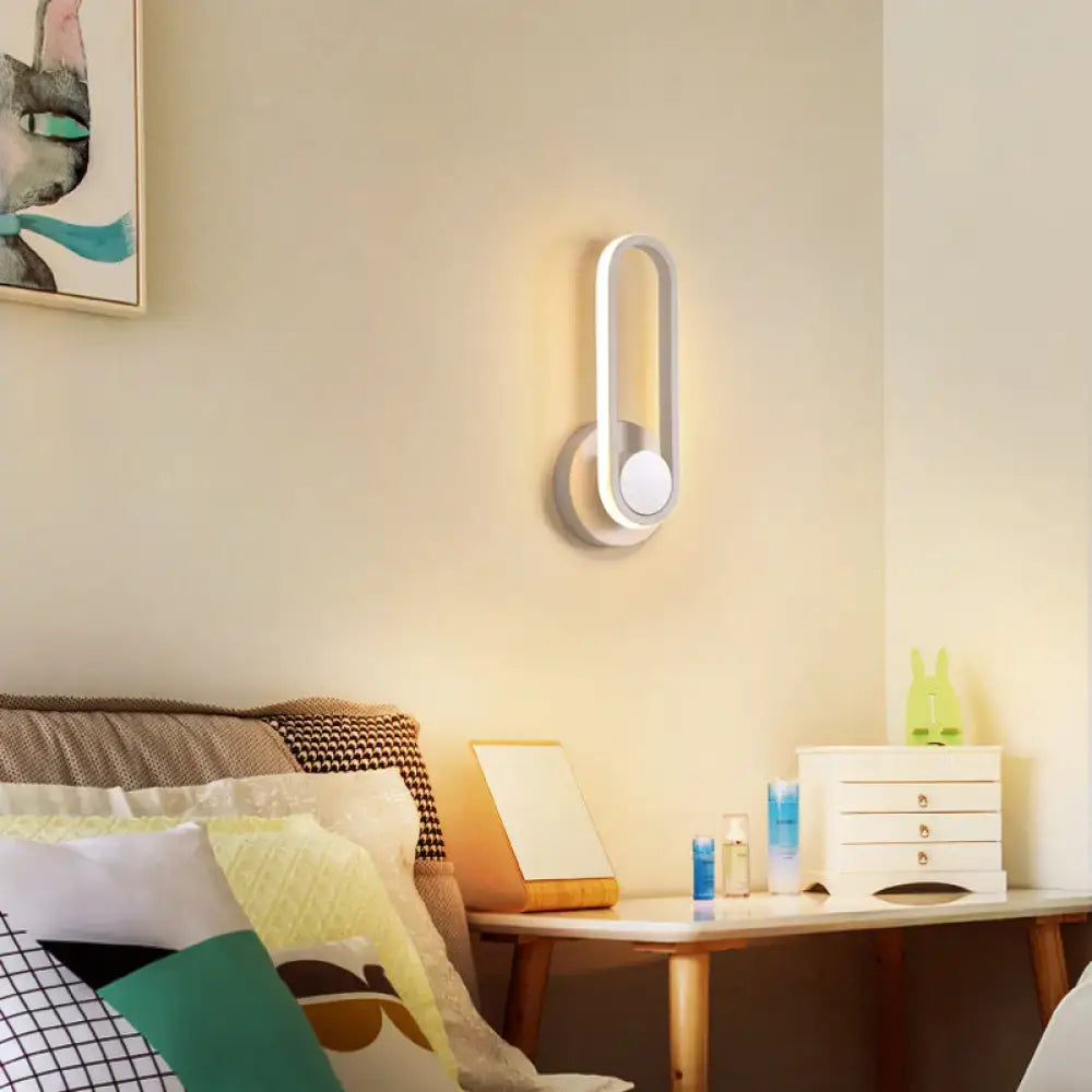 Modern minimalist black matte oval led wall sconce with sleek white design and warm ambient lighting for natural colors