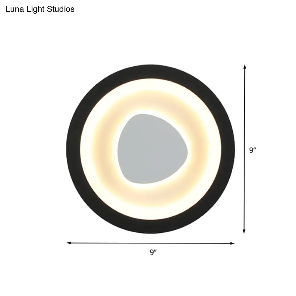 Modern minimalist black wall light with acrylic shade featuring a circular led ring and gray irregular center for bedroom
