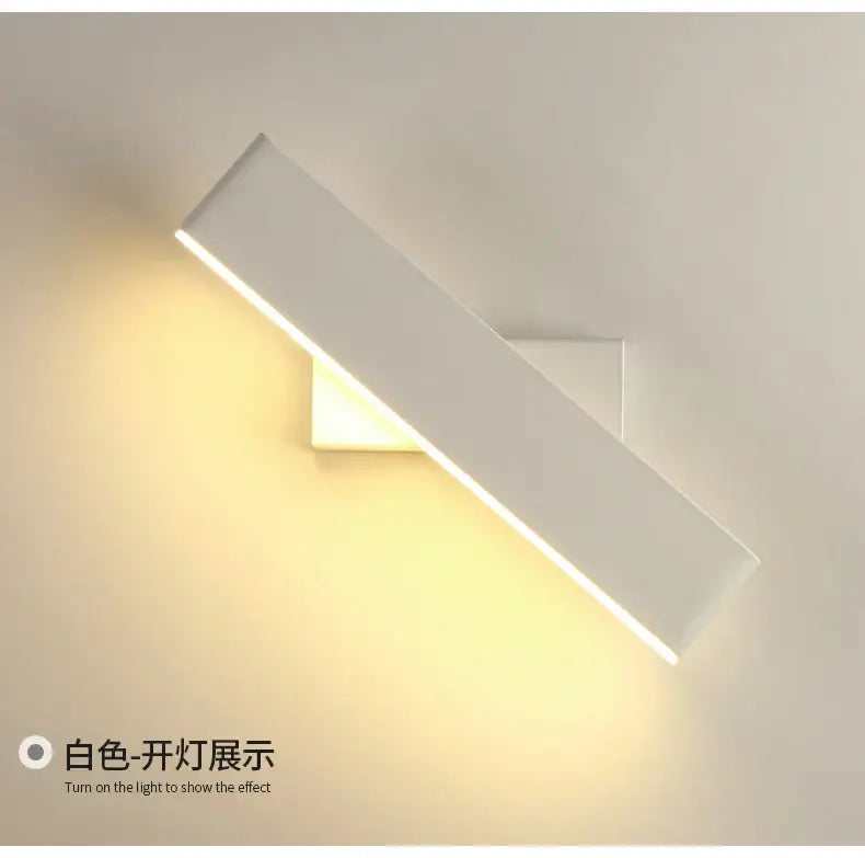 Modern minimalist black rotate wall lamp with sleek white rectangular sconce emitting warm ambient light for bedside reading