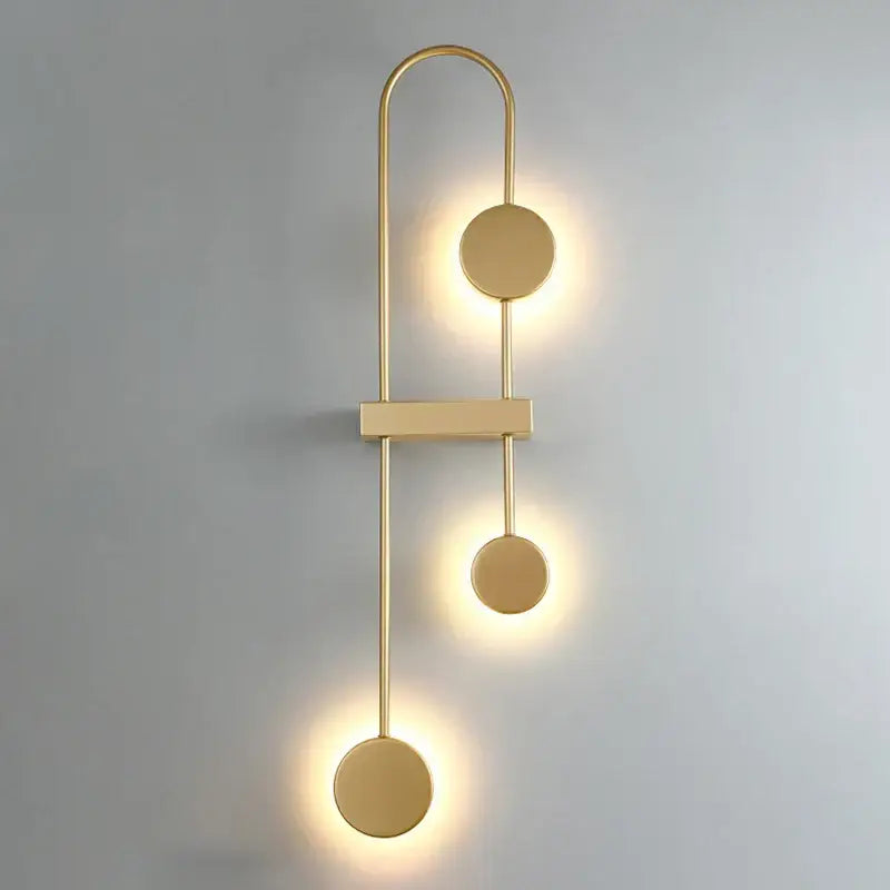 Modern minimalist black triple circle LED wall light with gold-toned metallic finish for bedroom decorbites led wall sconce