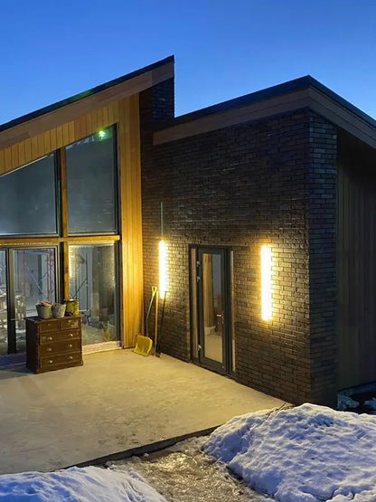 Modern minimalist black waterproof led wall light by decorbites with warm sconces on brick and wood house exterior