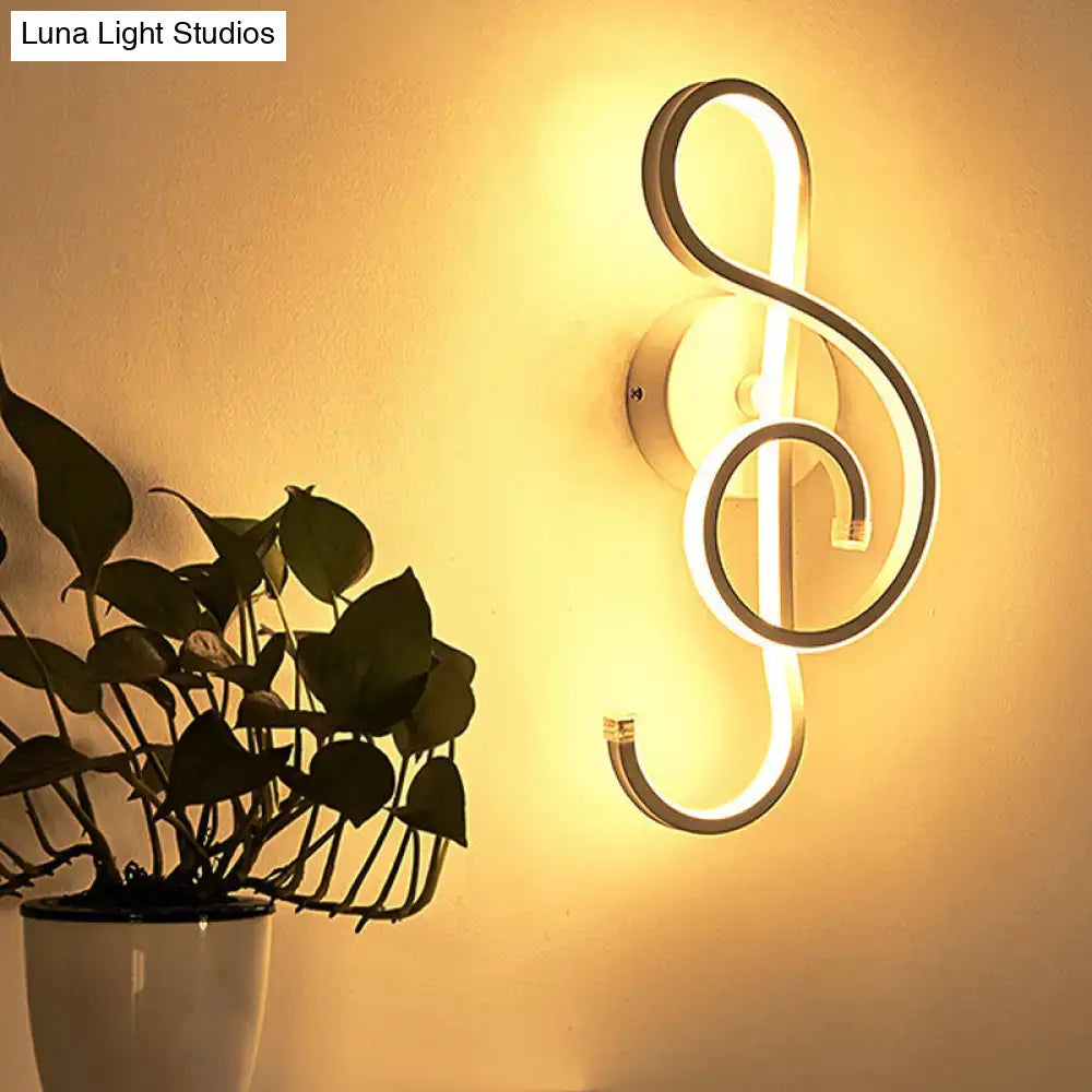 Modern minimalist black and white led ring sconce with sleek metallic treble clef design for bedroom wall lighting