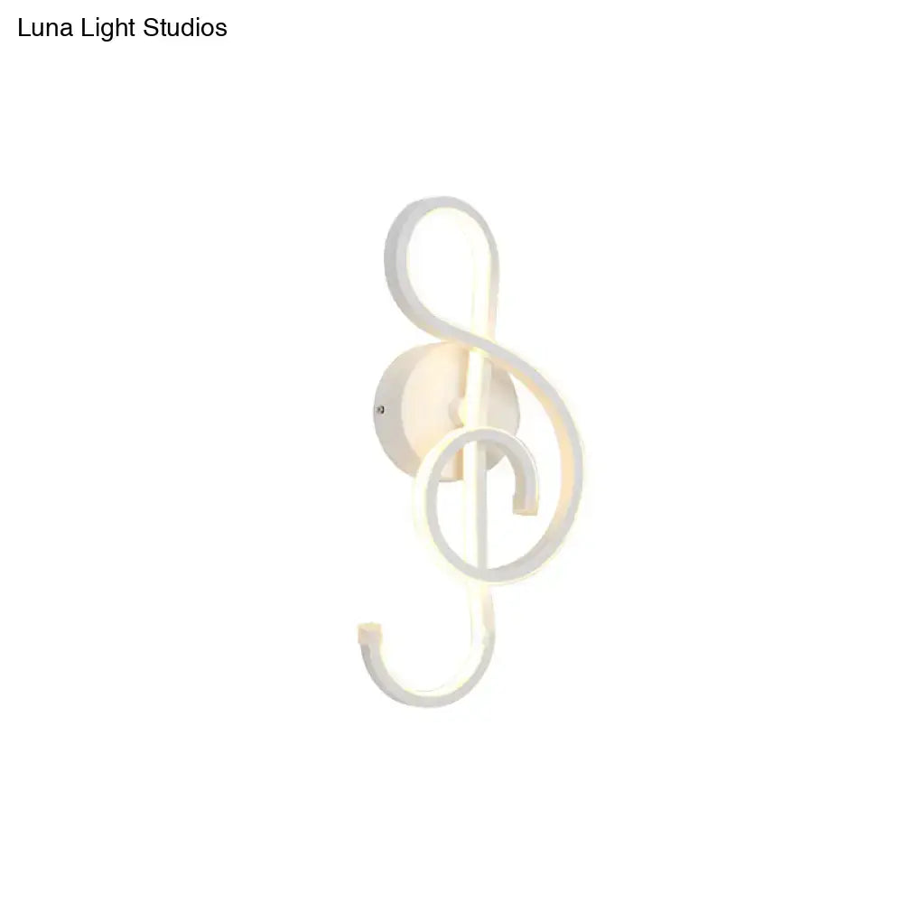 White led wall sconce shaped like a musical treble clef in modern minimalist black white bedroom wall light design