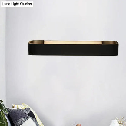 Modern minimalist black and white rectangular wall lamp with sleek metallic frame and warm ambient lighting for bedroom use
