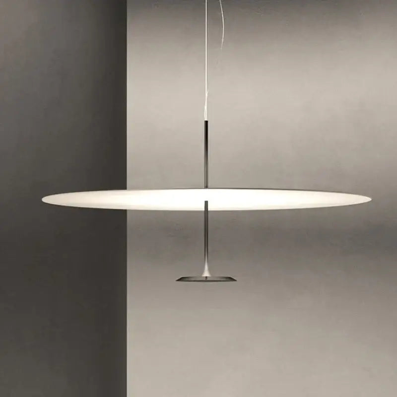 Modern minimalist black and white saucer pendant light with sleek chrome rod and base for cord pendant installation