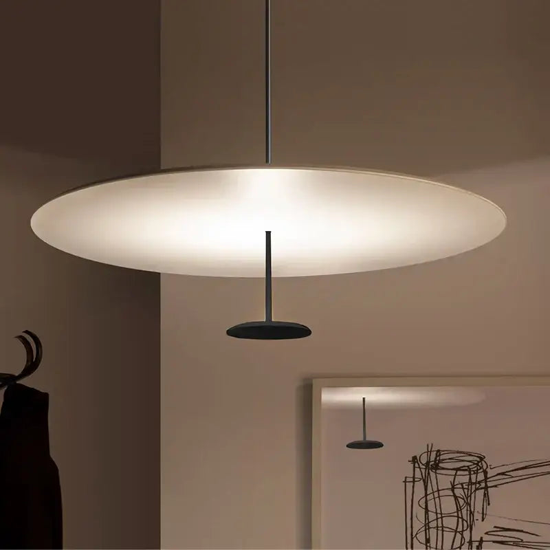 Modern minimalist black and white saucer pendant light with frosted glass shade and matte black metal frame for dining room cord pendant installation