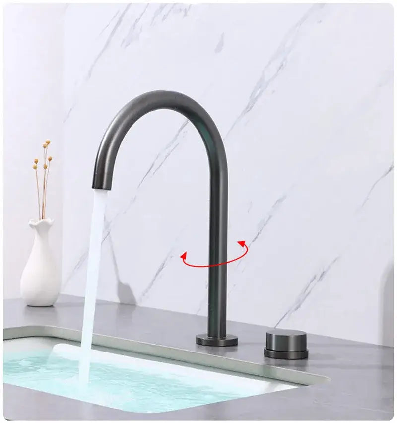 Modern matte black basin faucet with sleek curved spout and cylindrical handles contrasting decorbites brushed gold design