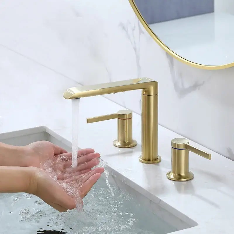 Modern minimalist brushed gold brass widespread bathroom faucet with gold brass widespread handles and sleek design