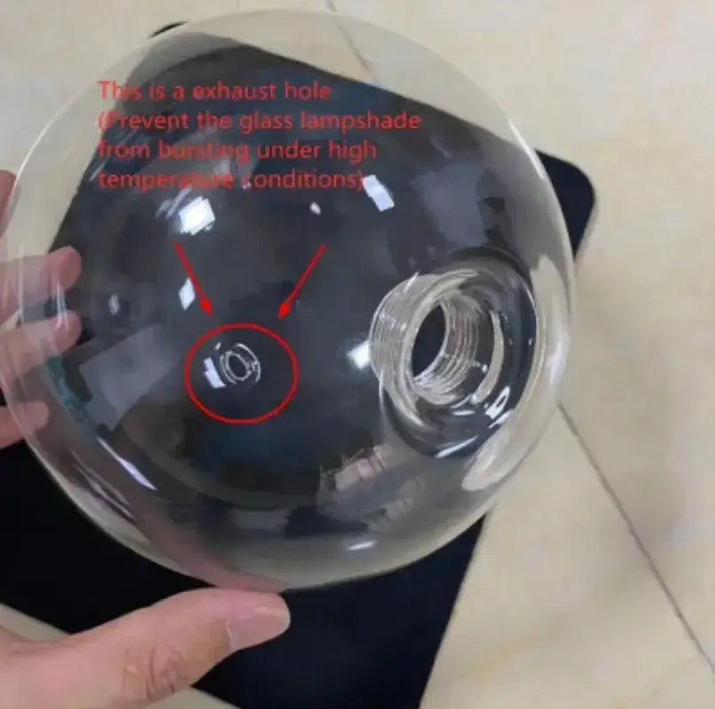 Clear glass ball pendant lamp with central exhaust hole and threaded opening for bulb attachment decorbites glass ball pendant lamp