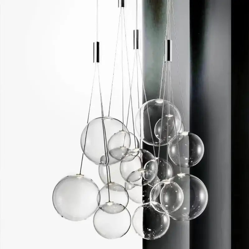 Modern minimalist pendant lamp featuring clear glass ball bulbs suspended by thin metallic cords for kitchen lighting decorbites glass ball