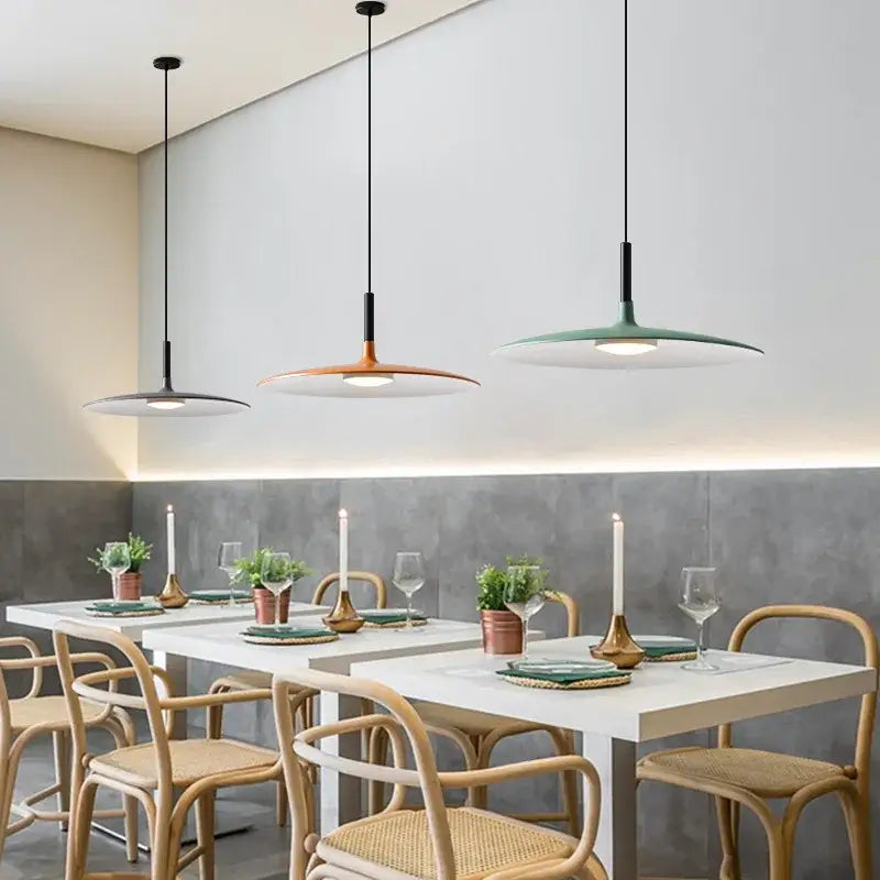 Three modern pendant lights with disc-shaped shades in matte gray copper and muted green for dining room decorbites colorful ufo pendant