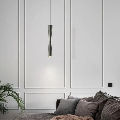 A sleek dark gray modern minimalist copper black gold pendant light with an elongated hourglass shape for dining room decorbites