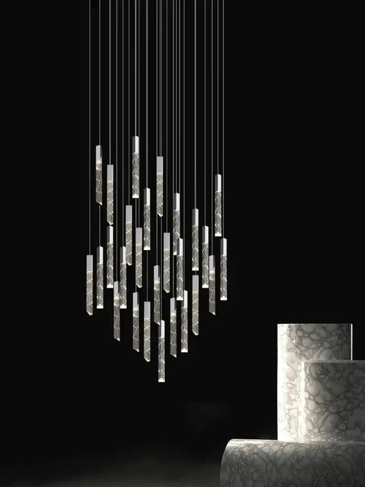 Modern minimalist crystal chrome led chandelier featuring slender etched cylindrical elements with warm ambient lighting