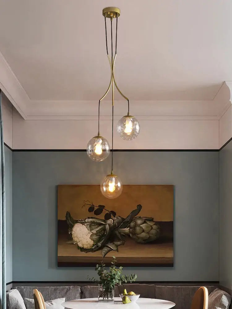 Brass-finished decorbites glass ball pendant light with three clear globe bulbs for modern minimalist decor