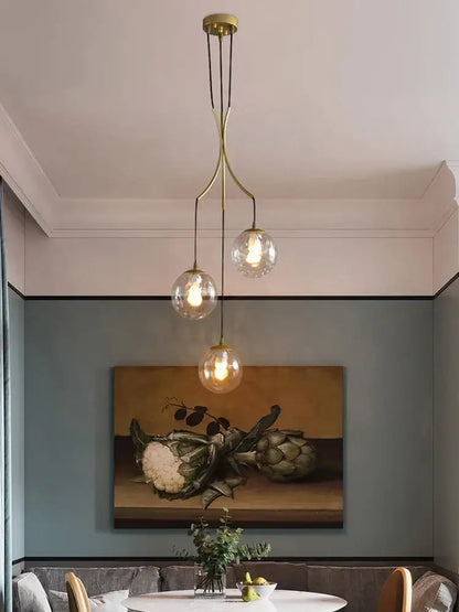 Brass-finished decorbites glass ball pendant light with three clear globe bulbs for modern minimalist decor