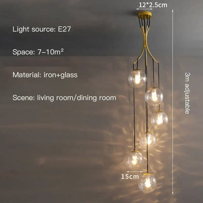 Gold-toned decorbites glass ball chandelier with five clear glass globes suspended from an iron frame for staircase lighting