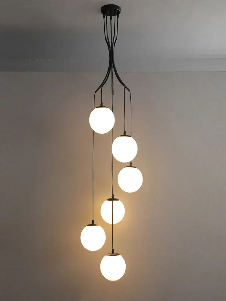 Modern black metal decorbites glass ball chandelier with five white glowing spherical globes for minimalist staircase lighting