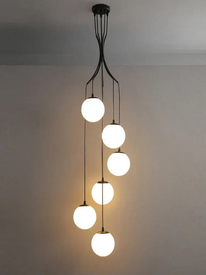 Modern black metal decorbites glass ball chandelier with five white glowing spherical globes for minimalist staircase lighting