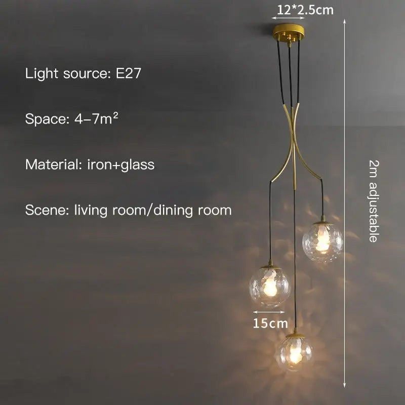Gold-toned iron and glass decorbites glass ball chandelier with three spherical bulbs suspended by black cords