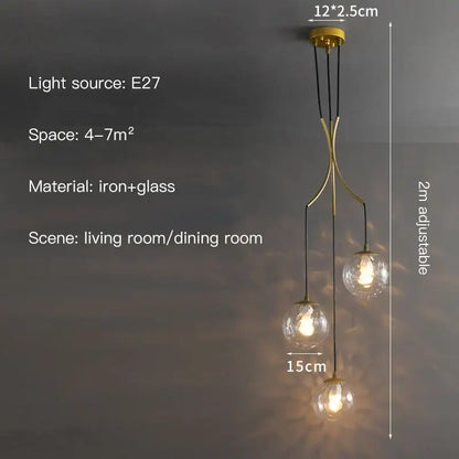 Gold-toned iron and glass decorbites glass ball chandelier with three spherical bulbs suspended by black cords